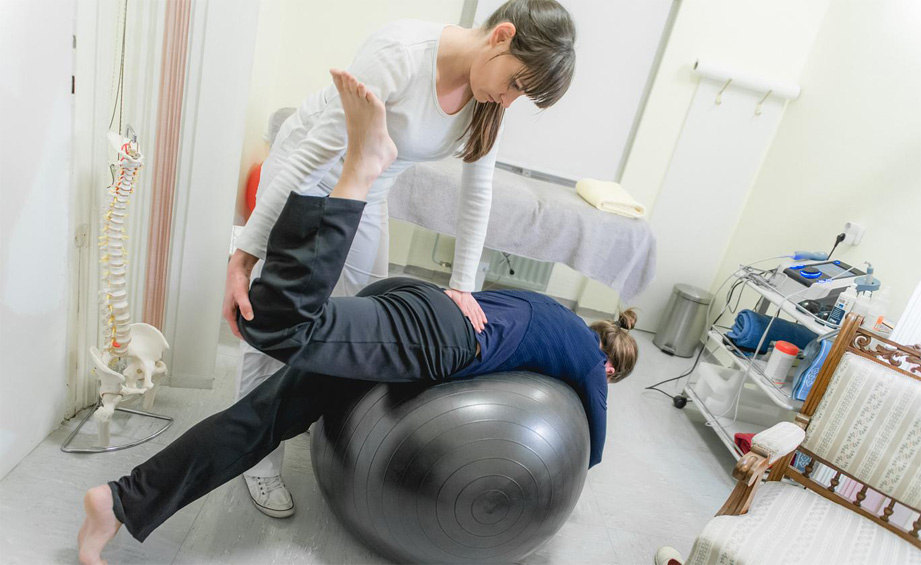 Patient Doing Pilates with Physical Therapists, Rehabilitation After Back Problem